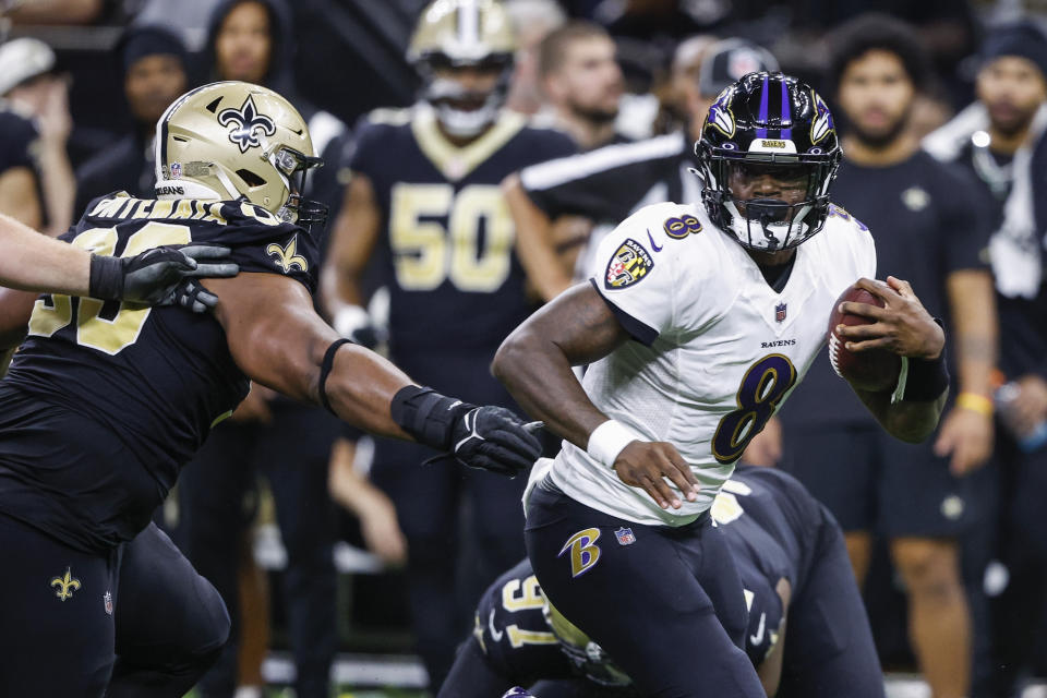 Baltimore Ravens quarterback Lamar Jackson (8) scrambles away from the New Orleans Saints defense in the second half of an NFL football game in New Orleans, Monday, Nov. 7, 2022. (AP Photo/Butch Dill)