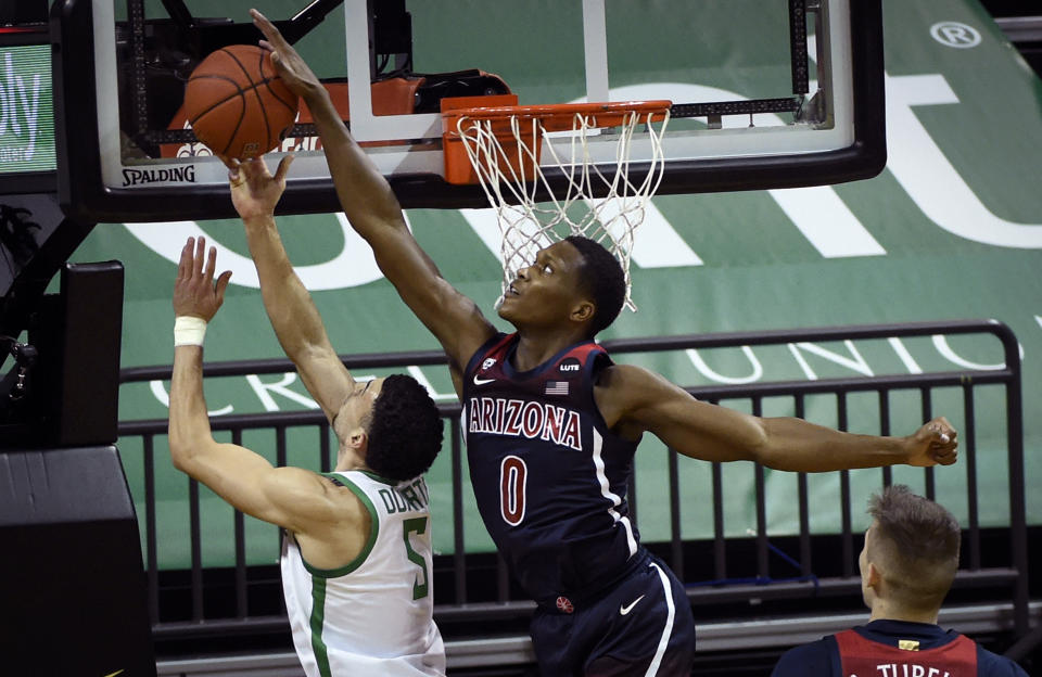 Arizona guard Bennedict Mathurin (0) blocks the shot of Oregon guard Chris Duarte (5) during the first half of an NCAA college basketball game Monday, March 1, 2021, in Eugene, Ore. (AP Photo/Andy Nelson)