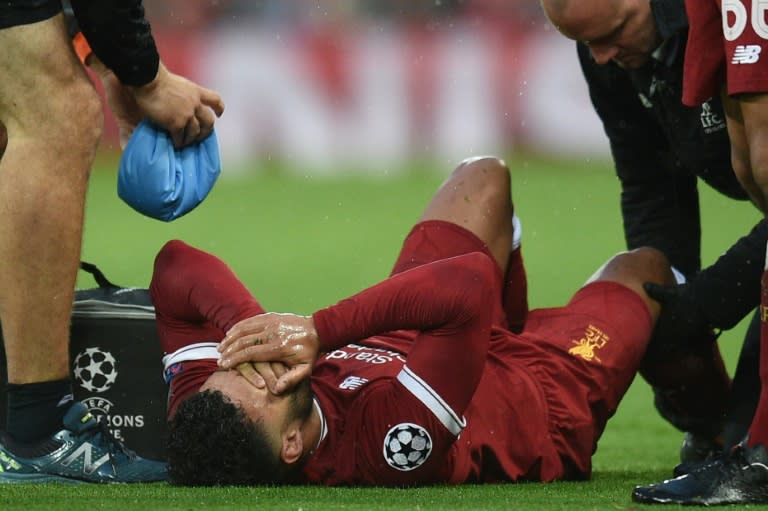 Liverpool and England midfielder Alex Oxlade-Chamberlain is treated on the pitch during the Champions League semi-final against Roma at Anfield