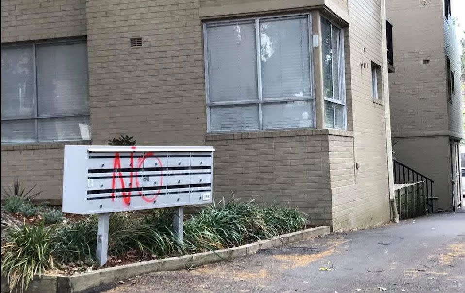 A letterbox in an apartment block is spray painted. Source: Facebook