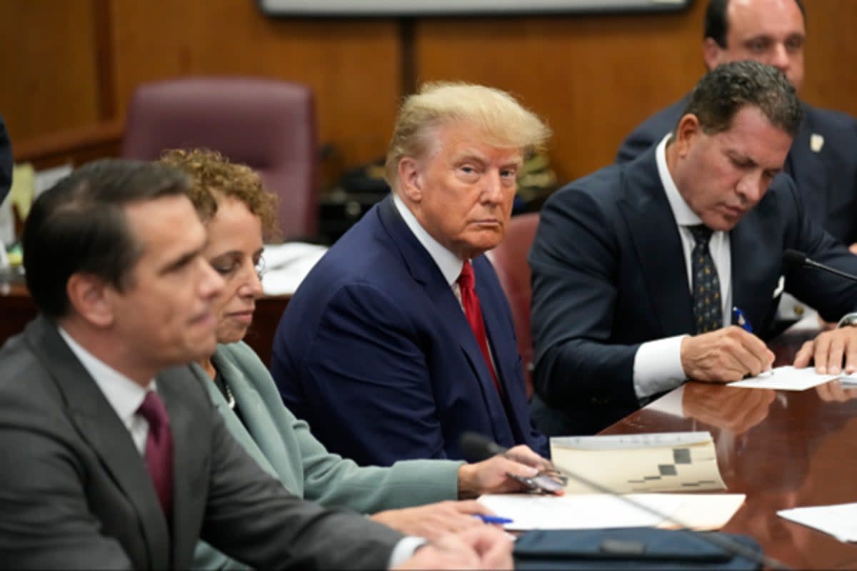 Former US President Donald Trump sits at the defense table with his defense team in a Manhattan court during his arraignment on April 4, 2023, in New York City (Getty Images)