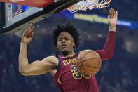 Cleveland Cavaliers' Isaac Okoro dunks against the Brooklyn Nets in the first half of an NBA basketball game, Monday, Jan. 17, 2022, in Cleveland. (AP Photo/Tony Dejak)