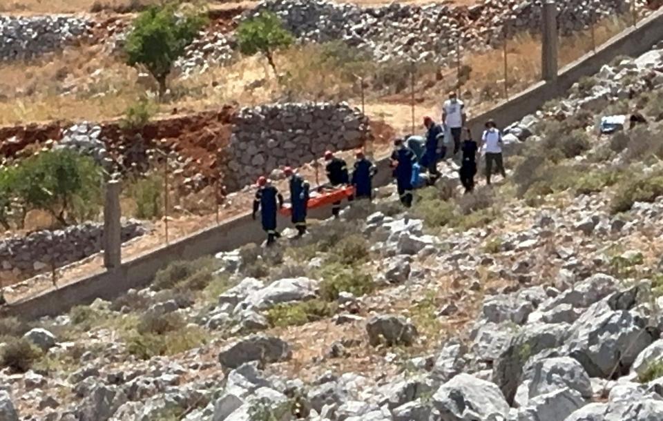 Rescuers transfer the body of British TV presenter Michael Mosley, after he was found dead following being reported missing, on the southeastern Aegean Sea island of Symi, Greece, June 9, 2024.