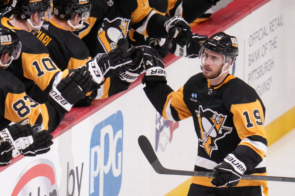 Pittsburgh Penguins' Reilly Smith (19) returns to the bench after scoring against the Calgary Flames during the third period of an NHL hockey game in Pittsburgh, Saturday, Oct. 14, 2023. (AP Photo/Gene J. Puskar)