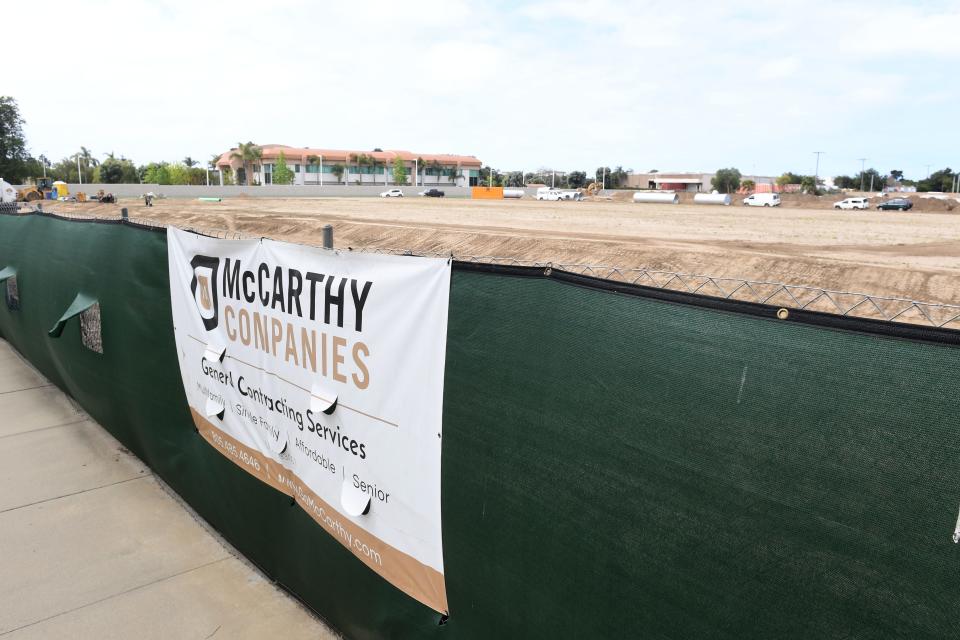 A contractor's sign is posted on a chain-link fence as construction starts on 341 apartments for seniors 55 and older in Oxnard.