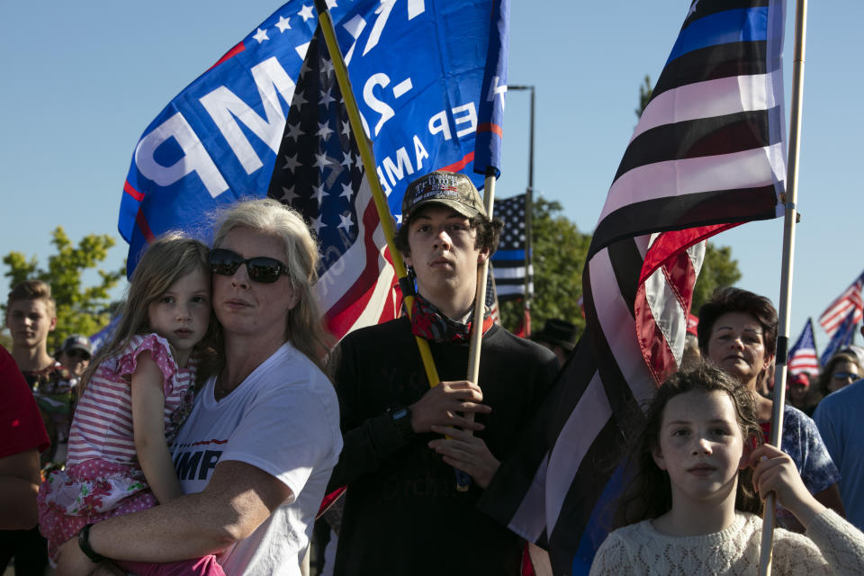 Supporters of President Donald Trump listen to speeches at a rally before a car parade, Saturday, Aug. 29, 2020, in Clackamas, Ore. (AP Photo/Paula Bronstein)