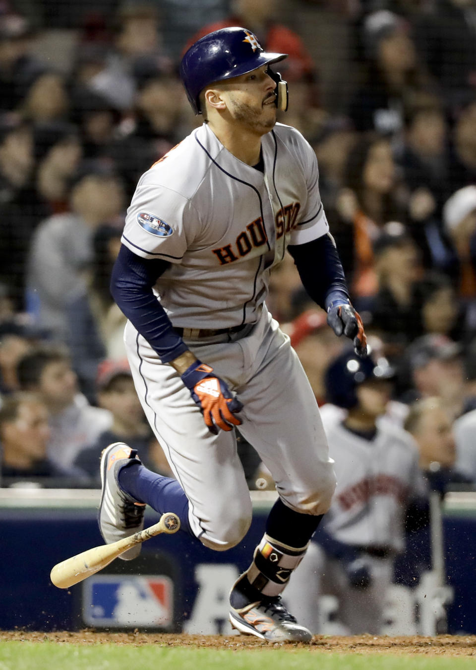 Houston Astros' Carlos Correa watch his RBI-single against the Boston Red Sox during the sixth inning in Game 1 of a baseball American League Championship Series on Saturday, Oct. 13, 2018, in Boston. (AP Photo/David J. Phillip)