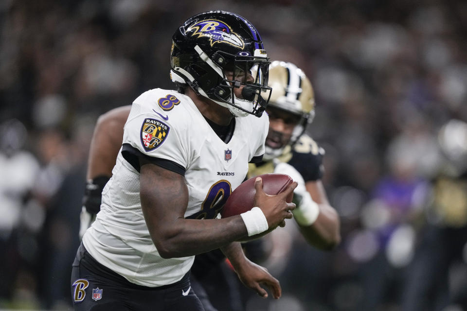 Baltimore Ravens quarterback Lamar Jackson (8) scrambles away from the New Orleans Saints defense in the second half of an NFL football game in New Orleans, Monday, Nov. 7, 2022. (AP Photo/Gerald Herbert)