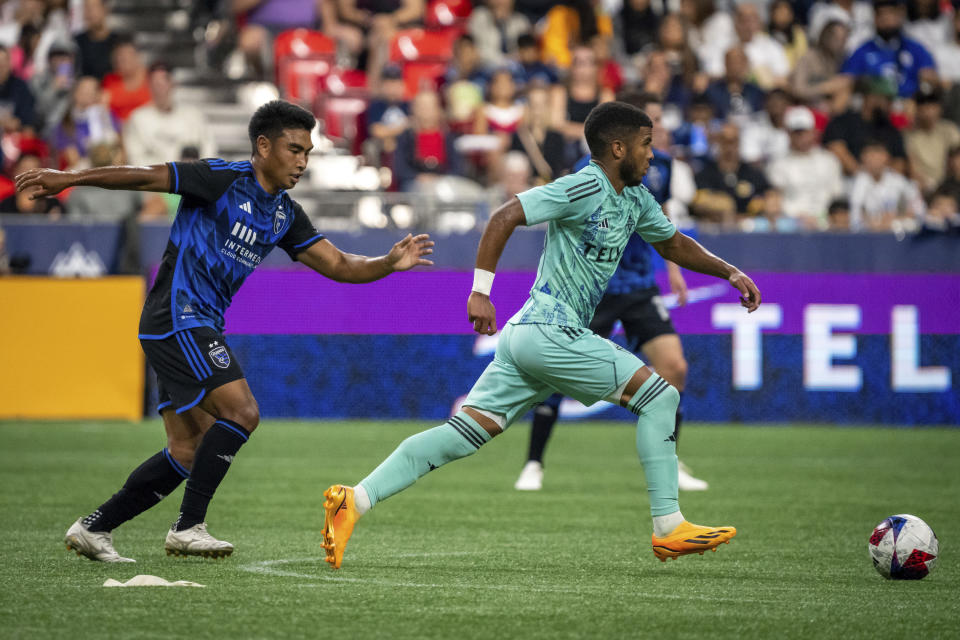 Vancouver Whitecaps' Pedro Vite, right,moves the ball away from San Jose Earthquakes' Michael Baldisimo, left, during first-half MLS soccer match action in Vancouver, British Columbia, Sunday, Aug. 20, 2023. (Ethan Cairns/The Canadian Press via AP)