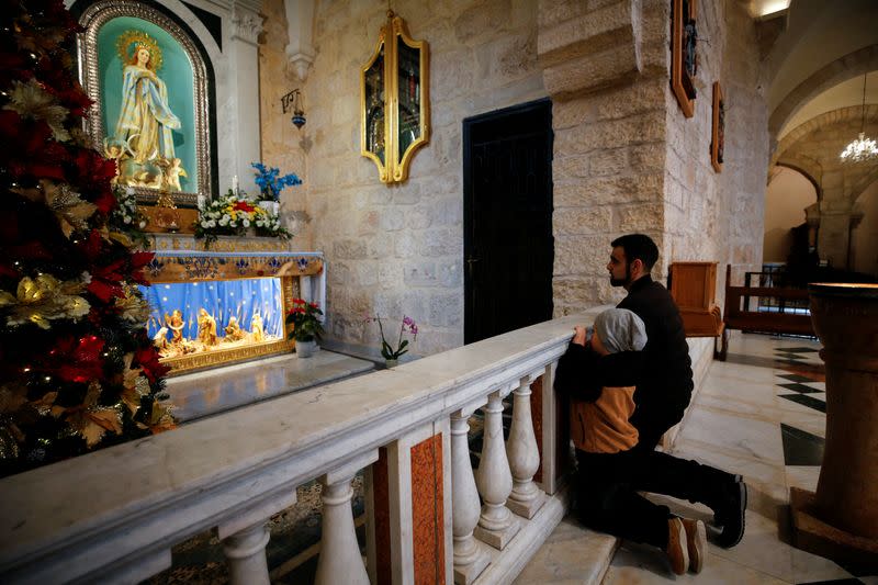 Worshippers attend Christmas morning mass as COVID-19 subdues festivities in Bethlehem