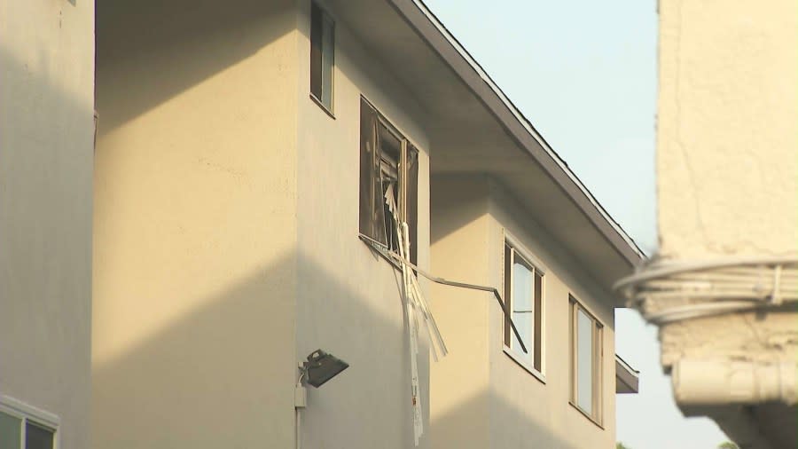 The shattered third-story window belonging to a man neighbors say are terrorizing a Baldwin Village apartment complex. (KTLA)