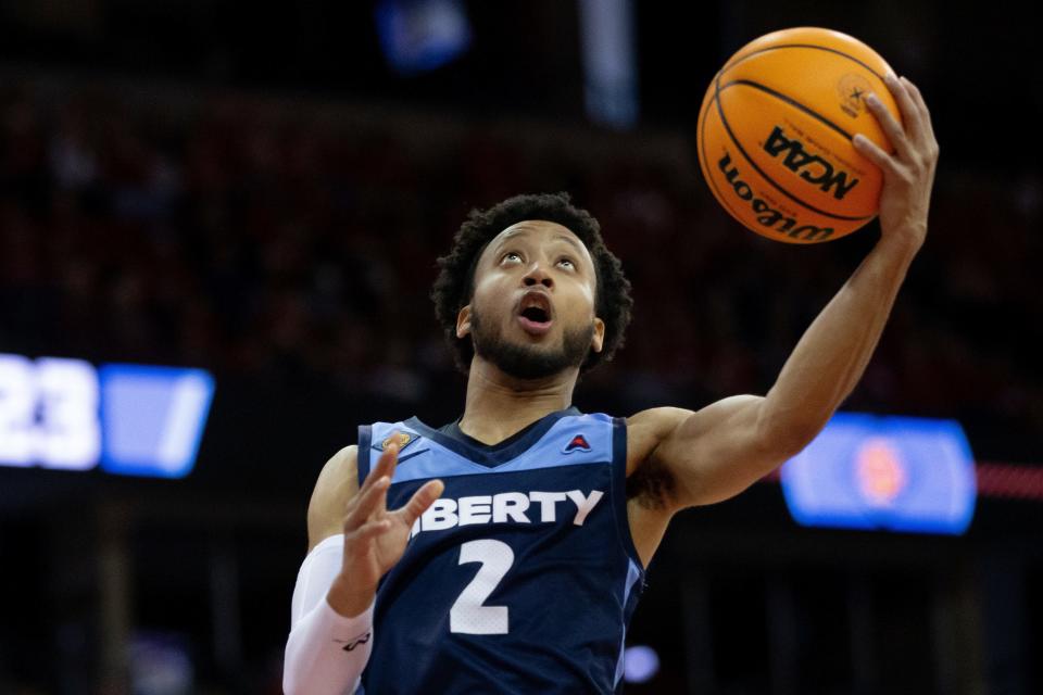 Liberty guard Darius McGhee (2) shoots the ball against the Wisconsin in the first half of a second round college basketball game in the National Invitational Tournament in Madison, Wis., Sunday, March 19, 2023. (Samantha Madar/Wisconsin State Journal via AP)