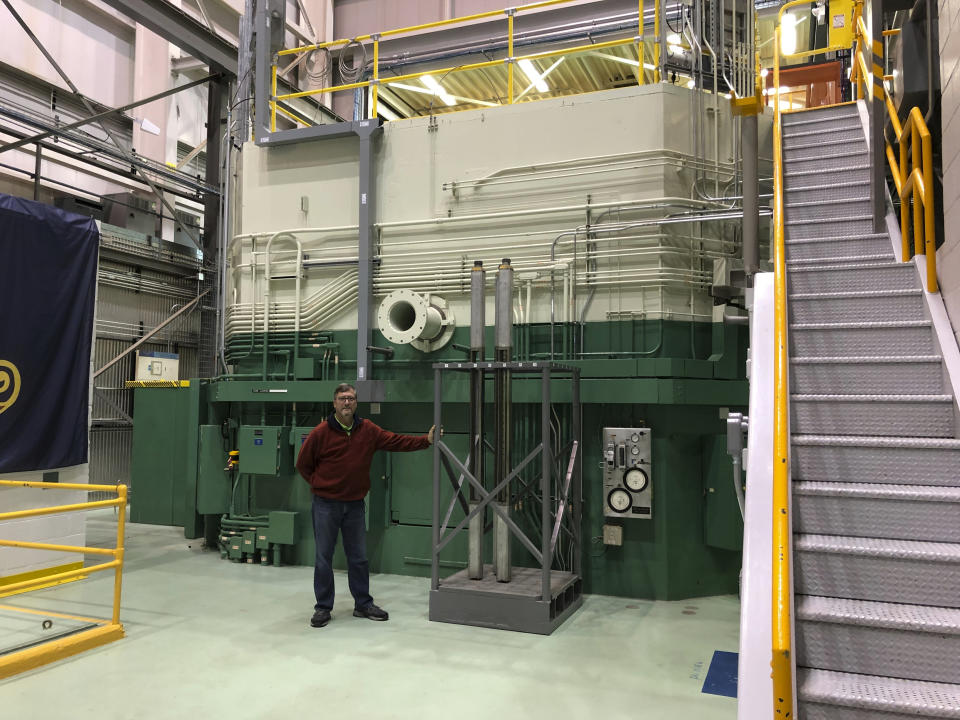 In this Nov. 29, 2018 photo, J.R. Biggs stands in front of the Transient Test Reactor he manages about 50 miles west of Idaho Falls, Idaho. The test reactor at the Idaho National Laboratory has been restarted to test nuclear fuels as the U.S. tries to revamp a fading nuclear power industry with safer fuel designs and a new generation of power plants. (AP Photo/Keith Riddler)