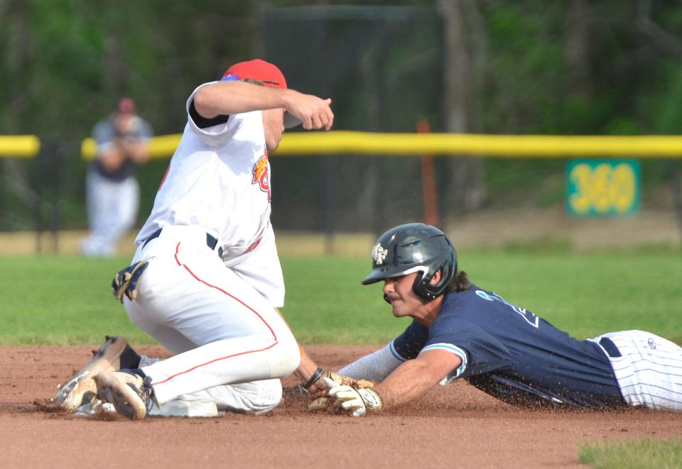 Brewster's Alex Freeland, right, slides into second base as Bourne's John Peck tries to tag him out during a first inning play. The Bourne Braves hosted the Brewster Whitecaps in Cape Cod Baseball League action Sunday night at Doran Park. Sunday was opening night for the Cape Cod Baseball League. To see more photos, go to www.capecodtimes.com/news/photo-galleries.