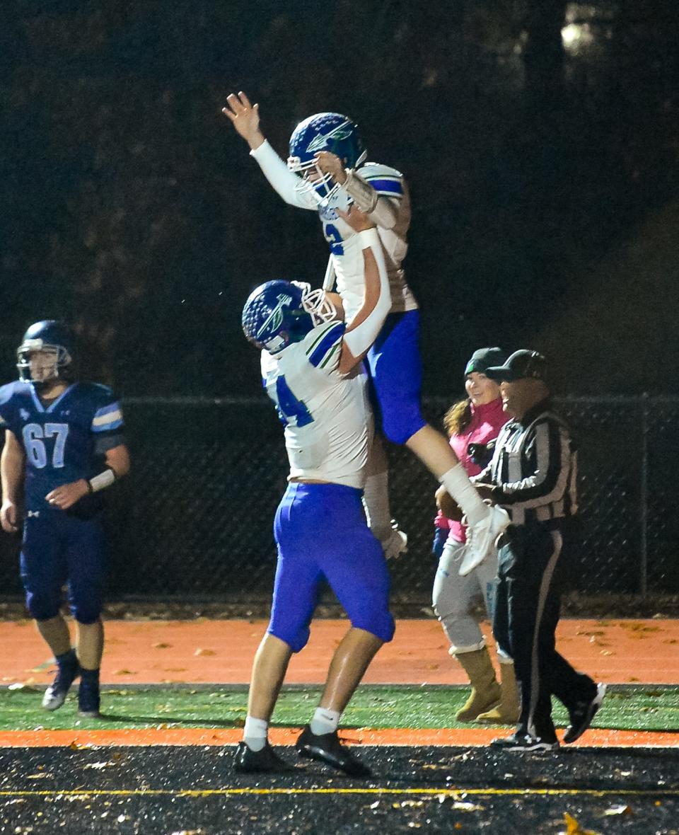 Blue Hills' James Bennett (54) and Adam Landers (12) celebrate after Landers scored during Wednesday’s game against Bristol-Plymouth.