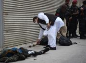 KARACHI, PAKISTAN - JUNE 29: Police officers inspect the site after gunmen attacked the Pakistani stock exchange building in Karachi, Pakistan on June 29, 2020. At least nine people were killed. The dead include four attackers, four Pakistan Stock Exchange security guards and a policeman, Muqaddas Haider, a city police chief, told reporters. At least seven people are also injured. (Photo by Sabir Mazhar/Anadolu Agency via Getty Images)