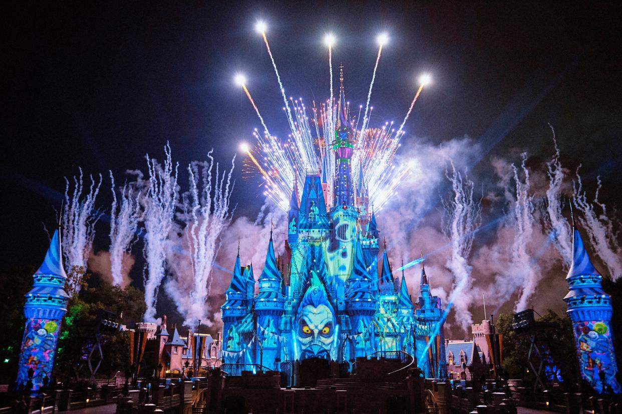 Projections and fireworks illuminate Cinderella Castle during Mickey's Not-So-Scary Halloween Party.