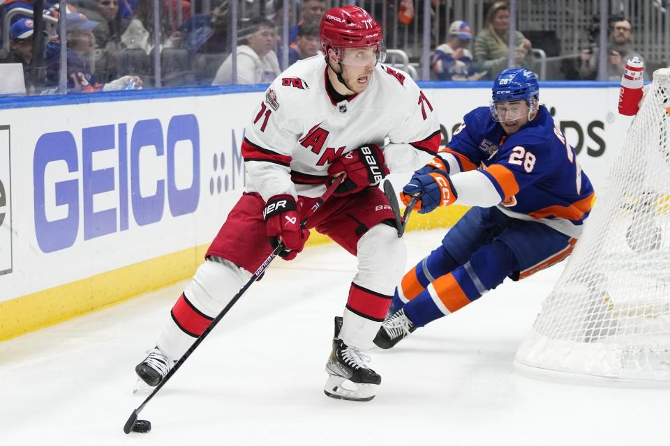 Carolina Hurricanes' Jesper Fast (71) looks to pass the puck away from New York Islanders' Alexander Romanov (28) during the third period of Game 6 of an NHL hockey Stanley Cup first-round playoff series Friday, April 28, 2023, in Elmont, N.Y. (AP Photo/Frank Franklin II)