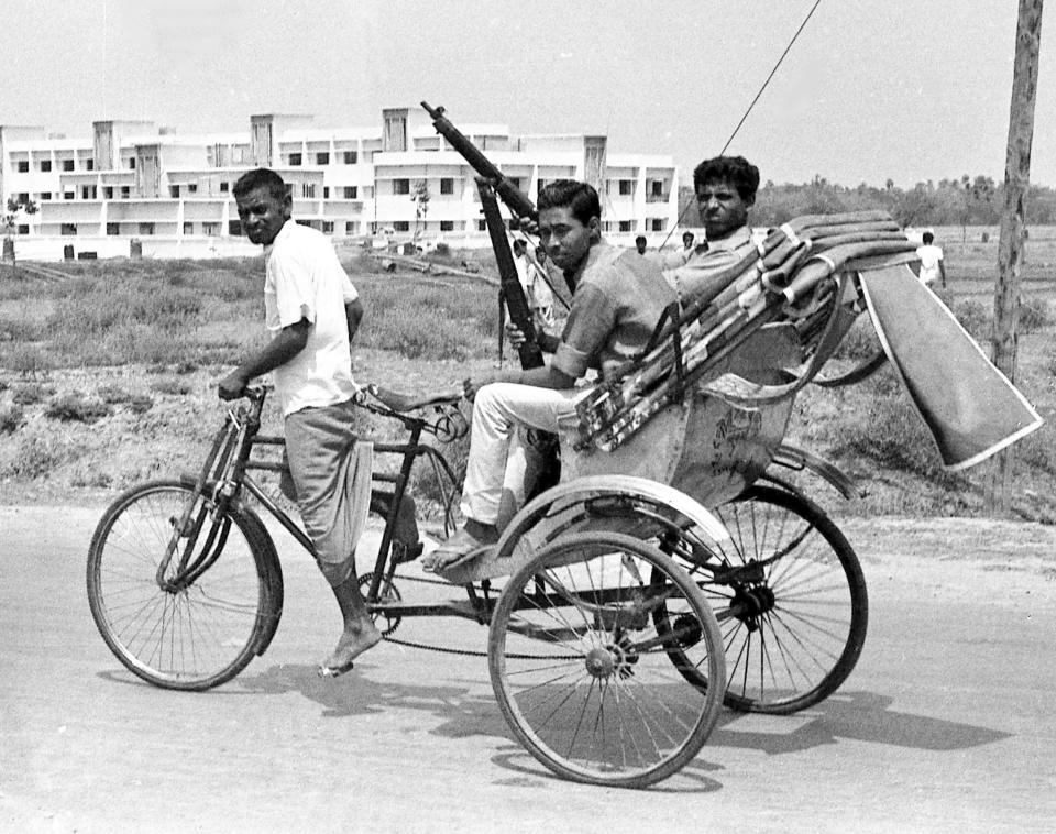 FILE - Armed East Pakistan fighters head for the battle front by pedicab, in Jessore, East Pakistan on April 2, 1971. The town, near the border with India, was the scene of fierce fighting between East Pakistan followers of Bengali nationalist leader Sheikh Mujibur Rahman and Pakistan Army forces. (AP Photo/File)