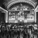 Commuters pass through Grand Central Station below an enormous Defense Bond mural, New York City, World War II, circa 1941. (Hulton Archive/Getty Images)