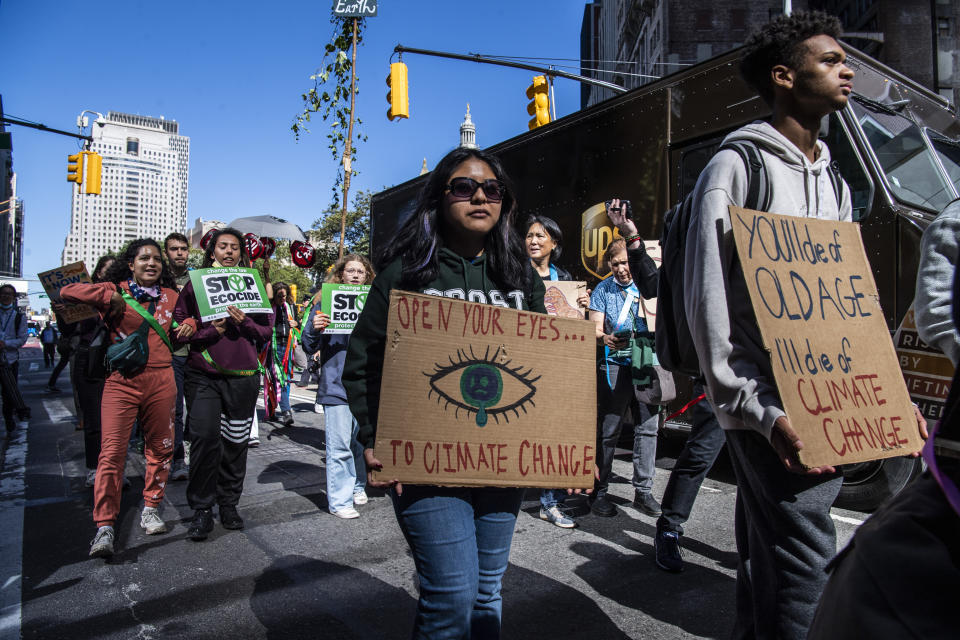 Activists gather and walk through lower Manhattan for the Global Climate Strike protests, Friday, Sept. 23, 2022, in New York. (AP Photo/Brittainy Newman)