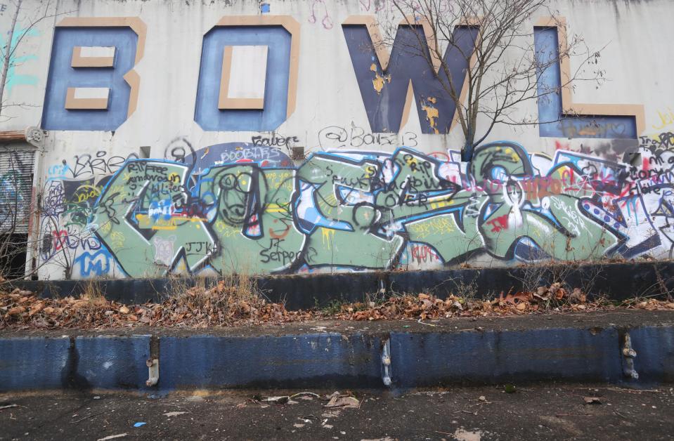 The Rubber Bowl's last remaining sections are covered in graffiti.