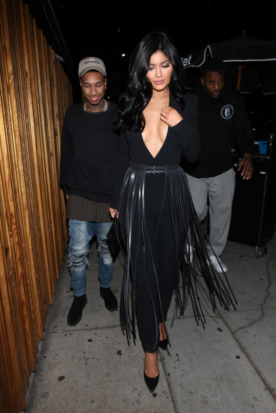 Kylie Jenner wears a black jumpsuit and fringed belt in Los Angeles.