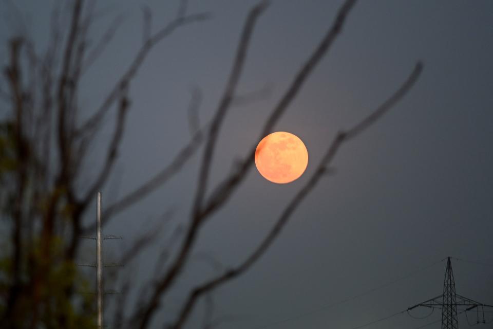 The moon is pictured over the skies of New Delhi on May 26, 2021 during a total lunar eclipse as stargazers across the Pacific are casting their eyes skyward to witness a rare "Super Blood Moon". (Photo by SAJJAD HUSSAIN / AFP) (Photo by SAJJAD HUSSAIN/AFP via Getty Images)