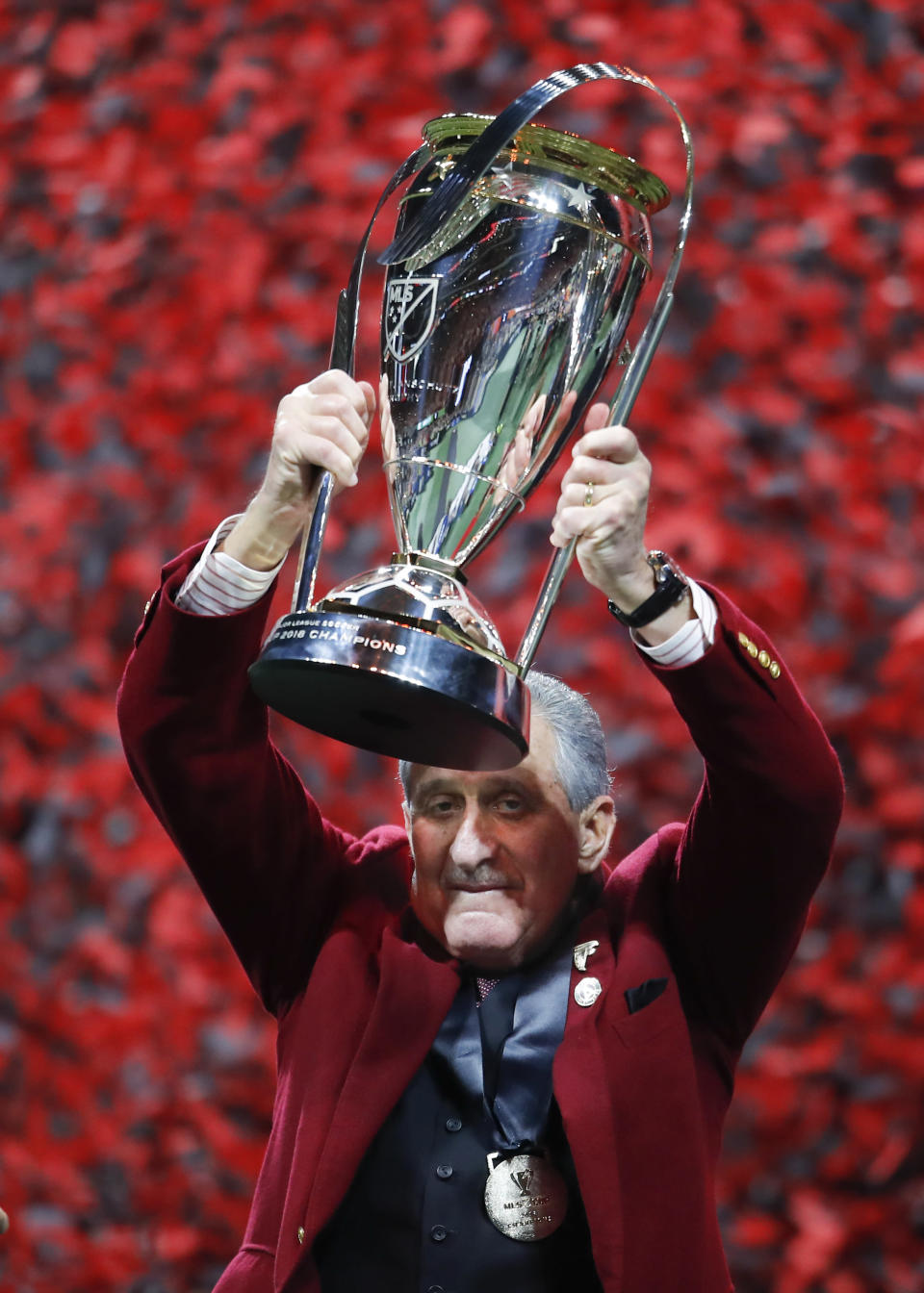 Atlanta United owner Arthur Blank holds up the trophy during the presentation after the MLS Cup championship soccer game against the Portland Timbers, Saturday, Dec. 8, 2018, in Atlanta. Atlanta United won 2-0. (AP Photo/Todd Kirkland)