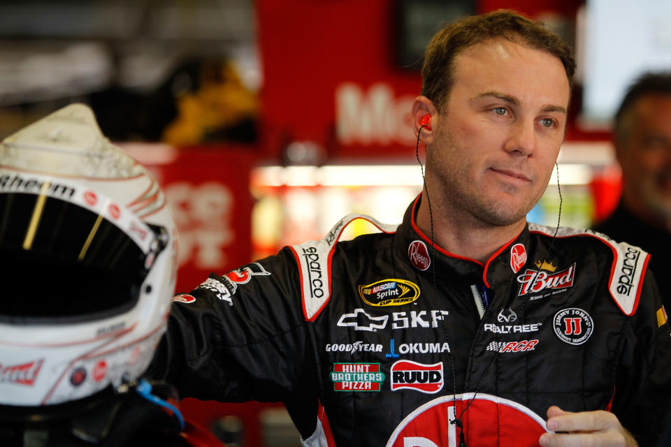 FORT WORTH, TX - NOVEMBER 05: Kevin Harvick, driver of the #29 Rheem Chevrolet, stands in the garage during practice for the NASCAR Sprint Cup Series AAA Texas 500 at Texas Motor Speedway on November 5, 2011 in Fort Worth, Texas. (Photo by Todd Warshaw/Getty Images for NASCAR)
