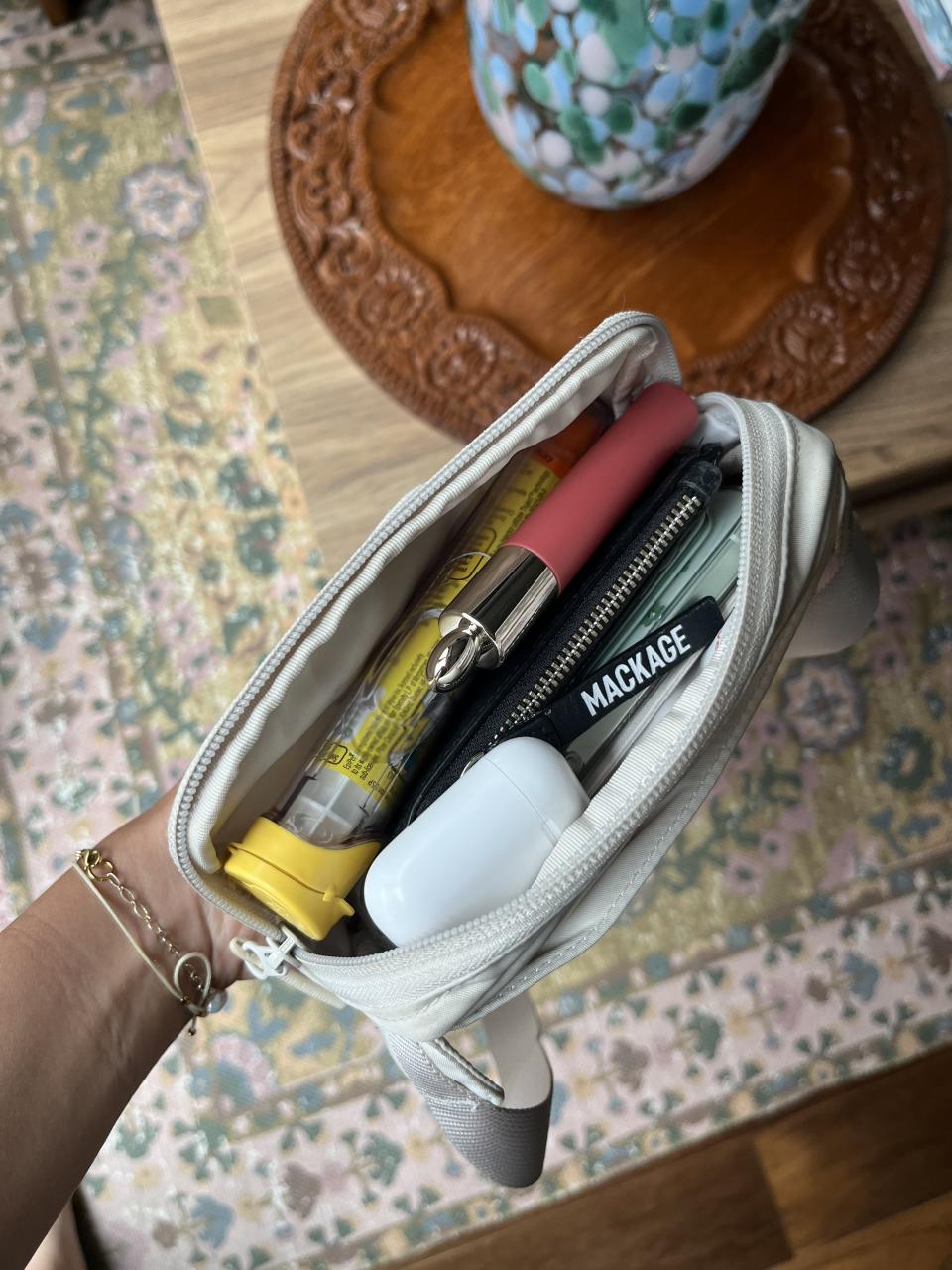 inside of lululemon mini belt bag with phone, wallet, airpods, lipgloss, epi-pen