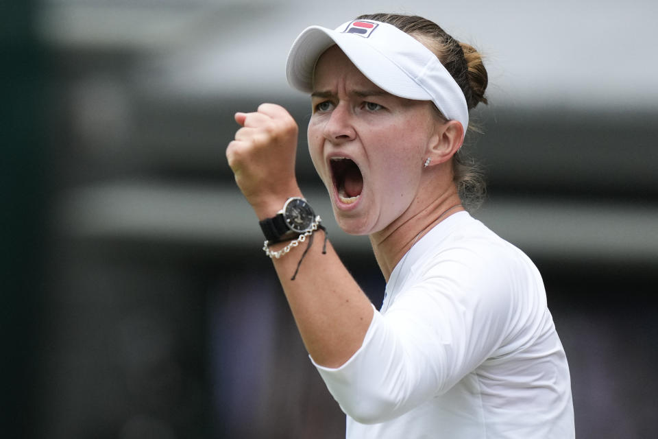 Barbora Krejcikova of the Czech Republic reacts after winning a point against Jelena Ostapenko of Latvia during their quarterfinal match at the Wimbledon tennis championships in London, Wednesday, July 10, 2024. (AP Photo/Mosa'ab Elshamy)