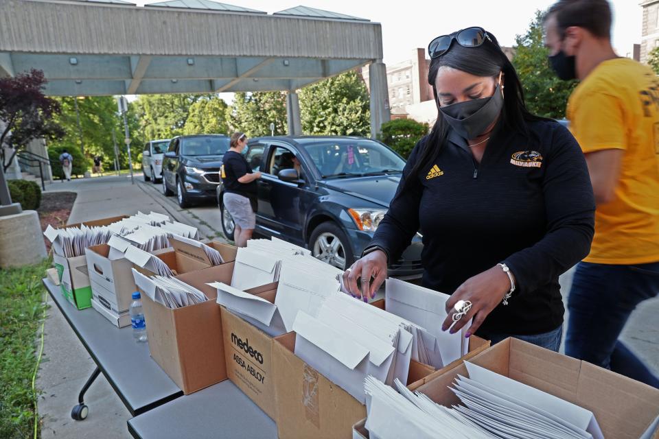 Arcetta Knautz, director of university housing, helps as students move in at the University of Wisconsin-Milwaukee’s Sandburg Residence Hall under COVID-19 restrictions. "It's sort of like a puzzle," Knautz said. "We can only have so many people moving in on the hour, on the half hour."