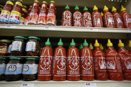 Bottles of Sriracha hot chili sauce, made by Huy Fong Foods, are seen on a supermarket shelf in San Gabriel, California October 30, 2013. REUTERS/Lucy Nicholson