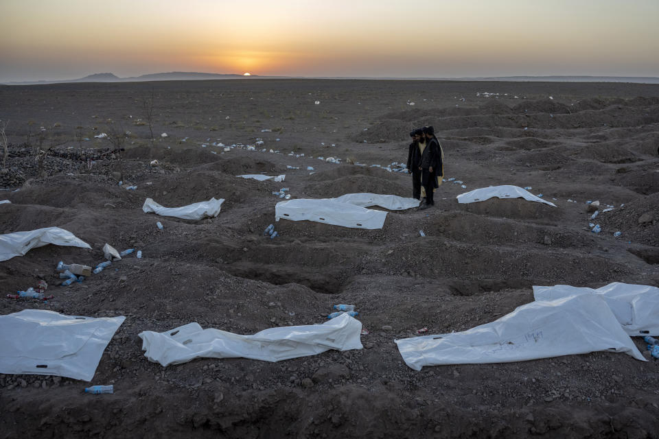 Afghans bury hundreds of people killed in an earthquake to a burial site, outside a village in Zenda Jan district in Herat province, western of Afghanistan, Monday, Oct. 9, 2023. Saturday's deadly earthquake killed and injured thousands when it leveled an untold number of homes in Herat province. (AP Photo/Ebrahim Noroozi)