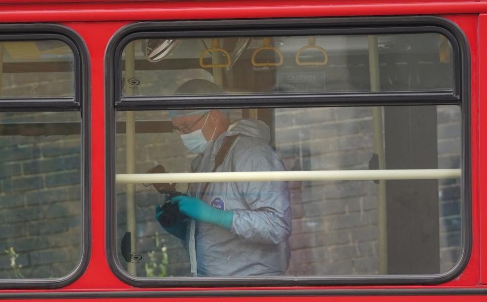 Forensic investigators examining a bus after a 15-year-old girl was stabbed to death (Lucy North/PA Wire)