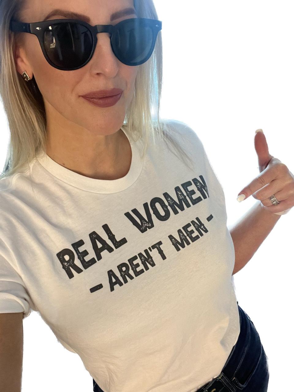 Sarasota School Board Chairwoman Bridget Ziegler points to a shirt that reads "real women aren't men", which she posted to her Twitter account April 2.