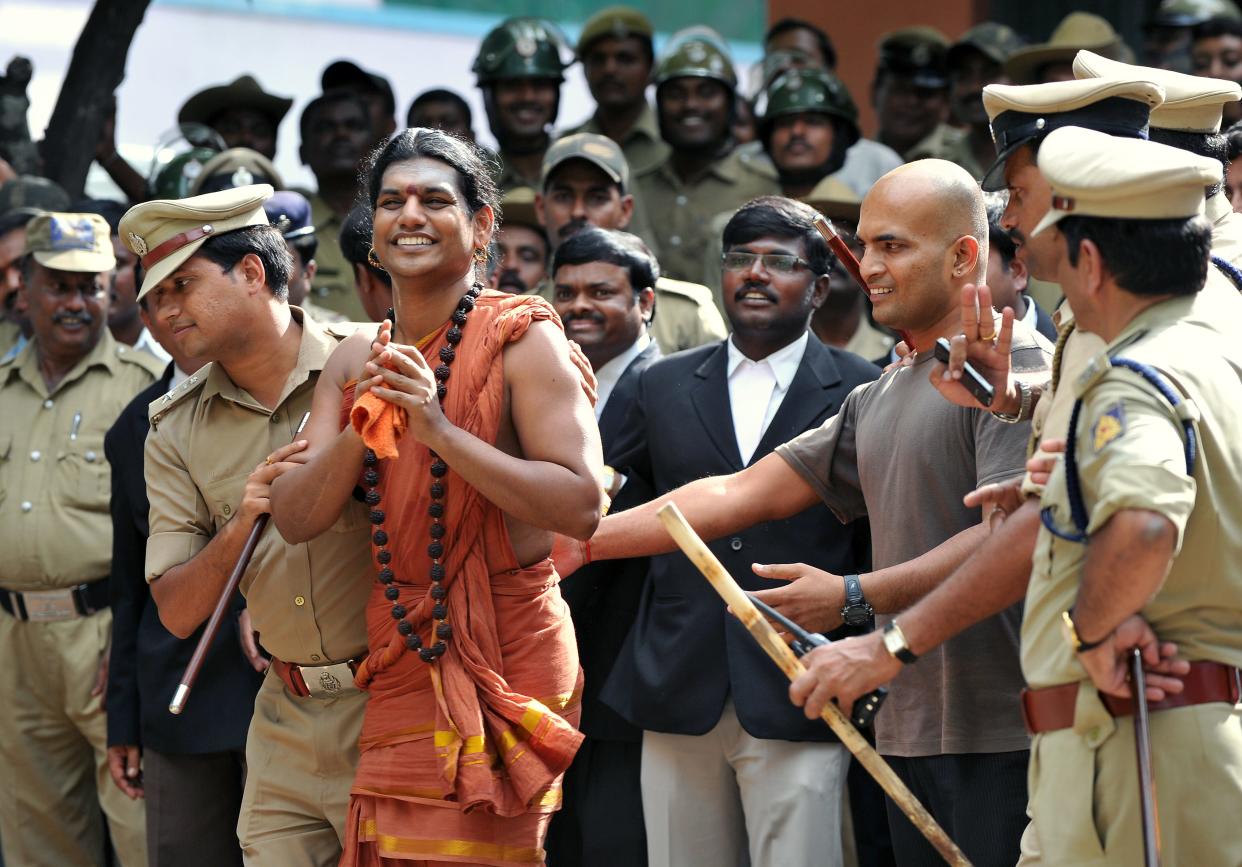 Police escort controversial Hindu Godman Swami Nityananda (2nd L) after appearing for his bail plea at the judicial magistrate court at Ramanagar District, some 50 kms from Bangalore, on June 14, 2012. A popular Indian guru facing a series of assault and sexual abuse charges was in police custody June 14 after he turned himself in to court authorities.