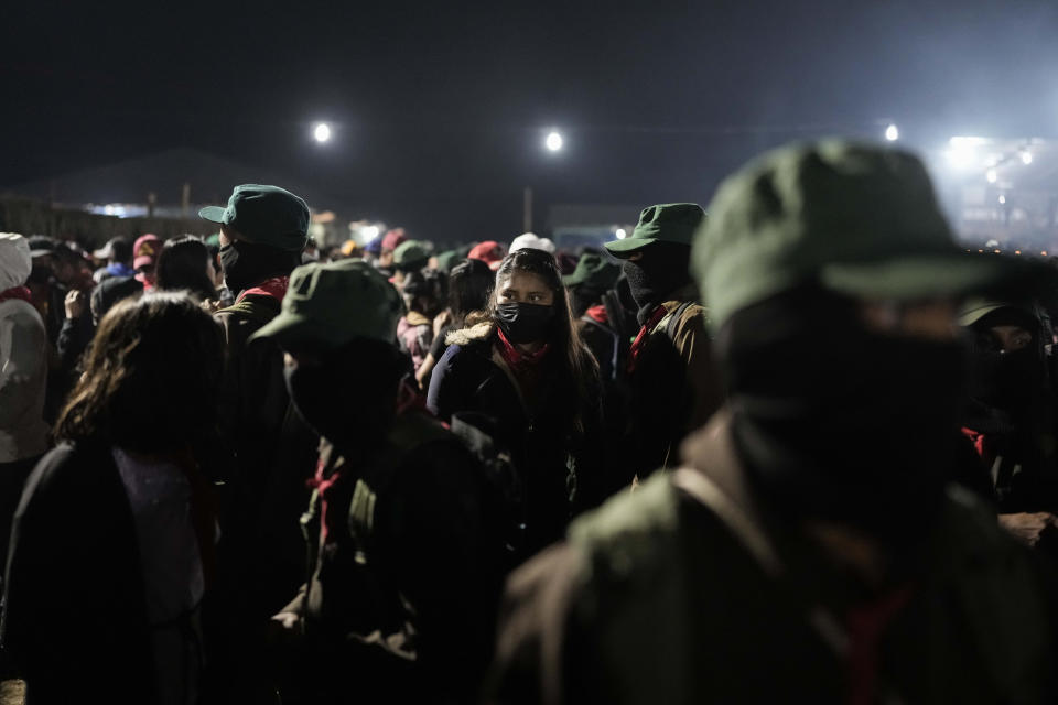 Members of the Zapatista National Liberation Army, EZLN, dance during an event marking the 30th anniversary of the Zapatista uprising in Dolores Hidalgo, Chiapas, Mexico, early Monday, Jan. 1, 2024. (AP Photo/Eduardo Verdugo)