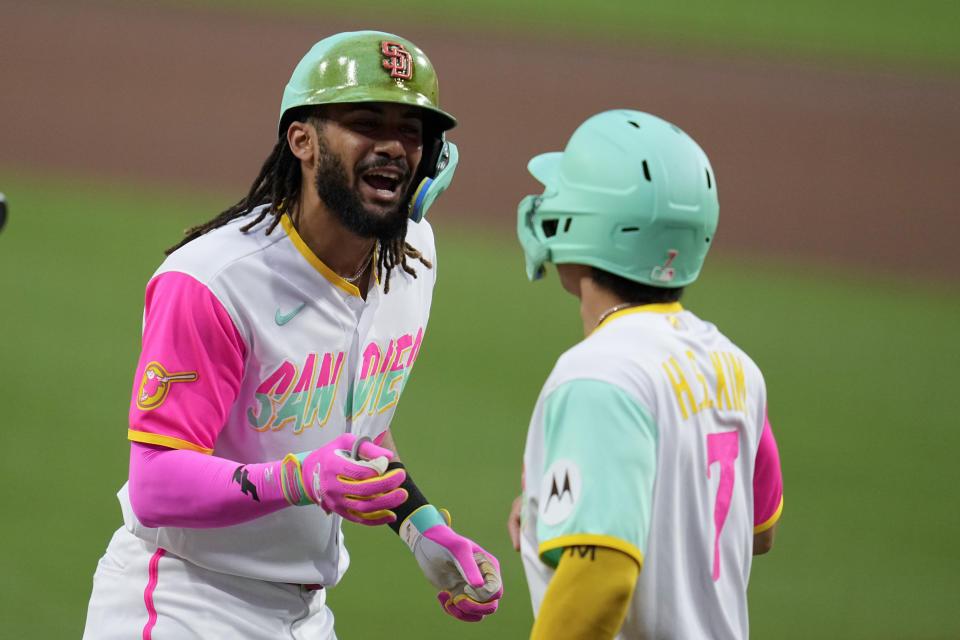 San Diego Padres' Fernando Tatis Jr., left, celebrates with teammate Ha-Seong Kim after hitting a two-run home run during the first inning of a baseball game against the San Francisco Giants, Friday, Sept. 1, 2023, in San Diego. (AP Photo/Gregory Bull)