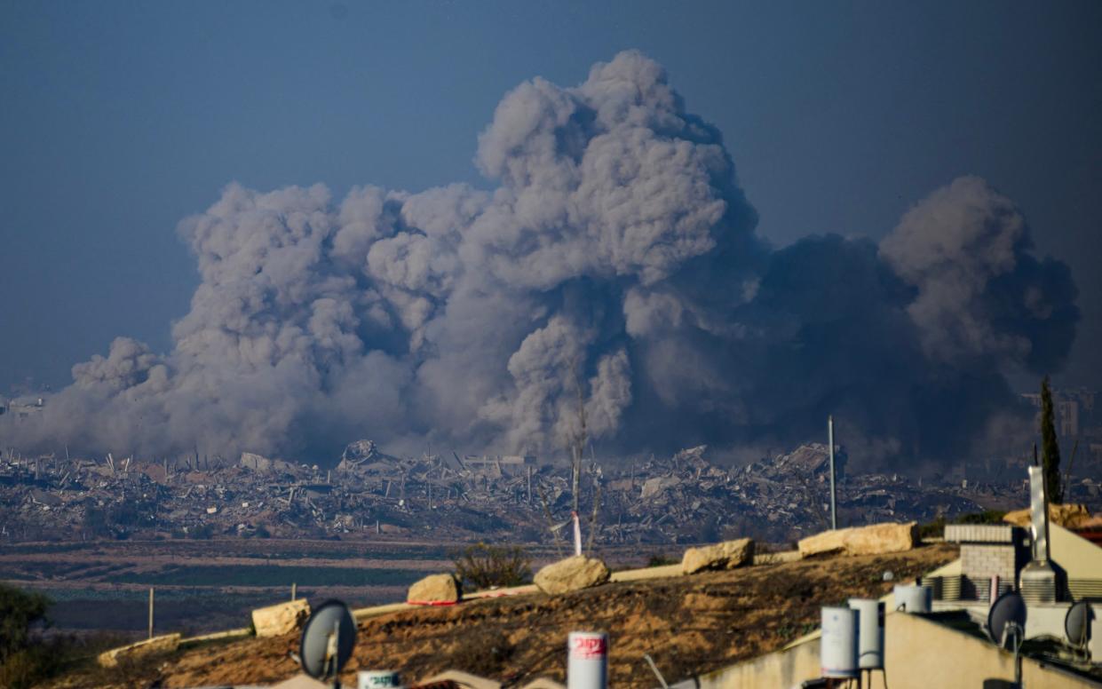 Smoke rises above the rubble in Gaza after an air strike this morning