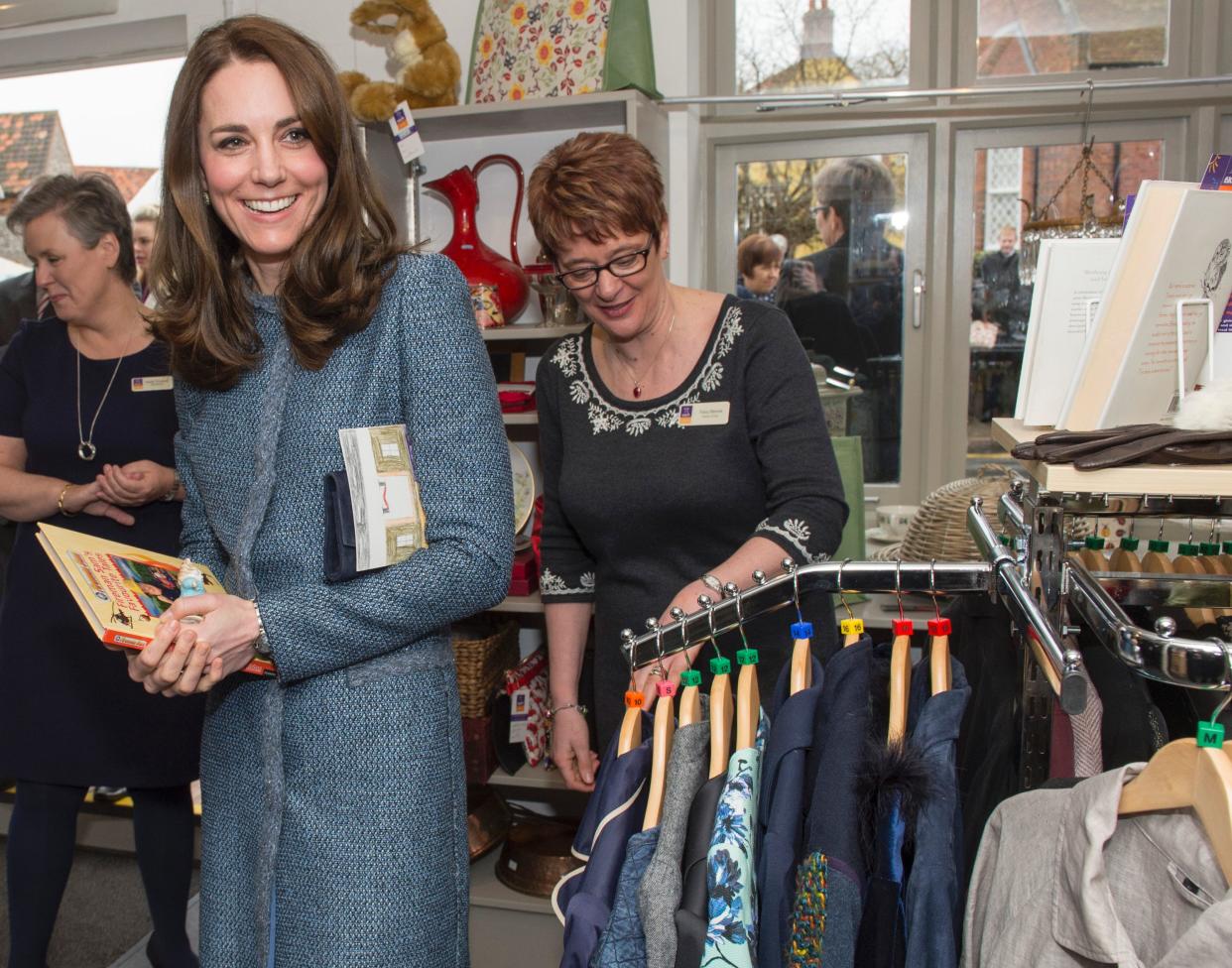 Britain's Catherine, Duchess of Cambridge, Royal Patron of East Anglias Childrens Hospices (EACH), is taken on a tour of the shop by Tracy Rennie (R), EACH Director of Care, on a visit to open a new EACH charity shop in Holt, eastern England on March 18, 2016.
EACH supports families and cares for children and young people with life-threatening conditions across Cambridgeshire, Essex, Norfolk and Suffolk. / AFP / POOL / Arthur Edwards        (Photo credit should read ARTHUR EDWARDS/AFP via Getty Images)