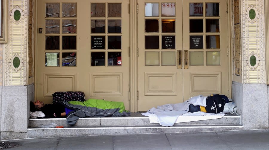 People sleep in the doorway of the American Conservatory Theater on May 11, 2023 in San Francisco. (Photo by Justin Sullivan / Getty Images)