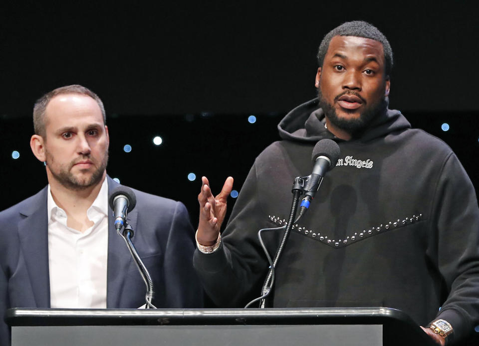 FILE - In this Jan. 23, 2019, file photo, musician Meek Mill, right, speaks about his incarceration along with Philadelphia 76ers co-owner Michael Rubin at the launch of REFORM Alliance in New York. With factories closed, tens of millions out of work and a recession looming because of the coronavirus pandemic, athletes, teams, entertainers and business leaders are donating prized possessions in response to a challenge to feed families suddenly in need. The “All In Challenge” was started by Rubin on Tuesday, April 14, 2020, and some of the biggest names in sports and entertainment have answered the call, including Meek Mill. (AP Photo/Kathy Willens, File)