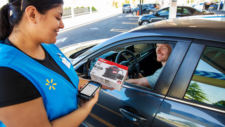 A Walmart customer picks up a package.