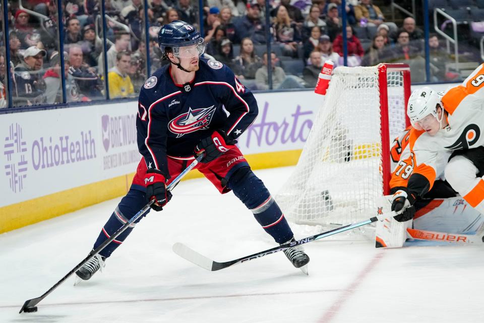 Columbus Blue Jackets defenseman Marcus Bjork skates around Philadelphia Flyers defenseman Travis Sanheim.