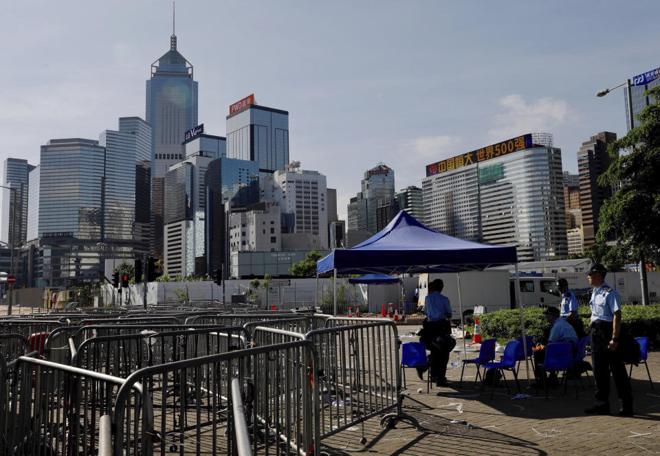 Police officers watch over an area near the Legislative Council in Hong Kong on Friday, June 14, 2019. Calm appeared to have returned to Hong Kong after days of protests by students and human rights activists opposed to a bill that would allow suspects to be tried in mainland Chinese courts. (AP Photo/Vincent Yu)