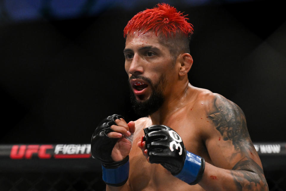 Jul 22, 2023; London, UNITED KINGDOM; Davey Grant (red gloves) fights Daniel Marcos (blue gloves) during UFC Fight Night at O2 Arena. Mandatory Credit: Per Haljestam-USA TODAY Sports