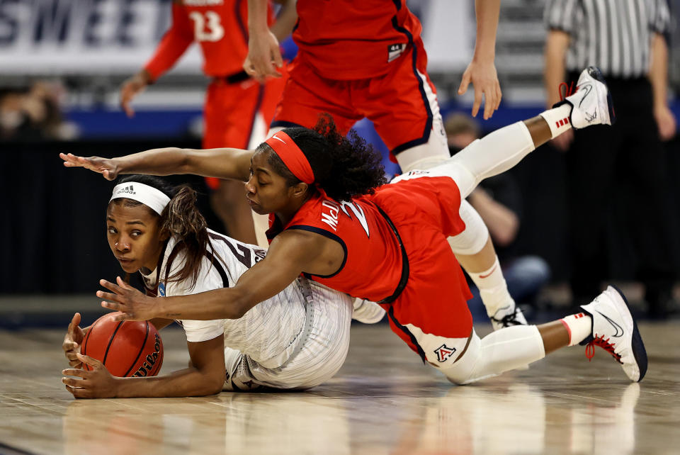 SAN ANTONIO, TEXAS - MARCH 27: Aaliyah Wilson #2 of the Texas A&M Aggies and Aari McDonald #2 of the Arizona Wildcats fight for the loose ball in the first half during the Sweet Sixteen round of the NCAA Women's Basketball Tournament at the Alamodome on March 27, 2021 in San Antonio, Texas. (Photo by Elsa/Getty Images)