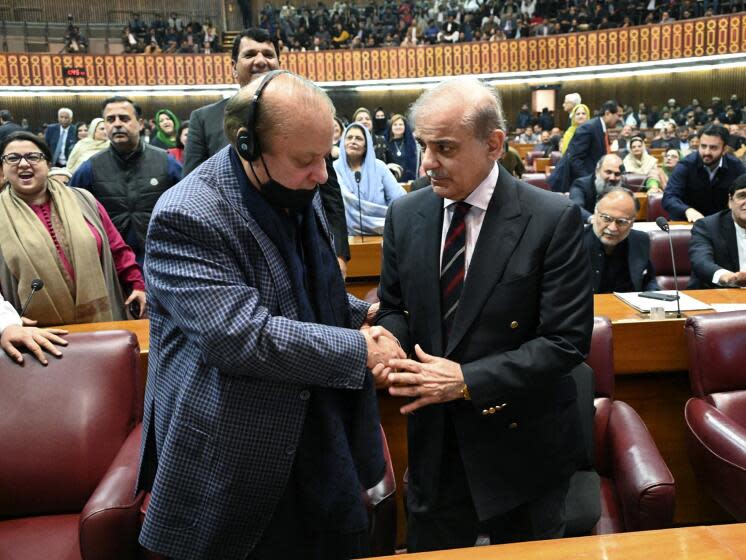 In this photo released by the National Assembly office, Pakistan's newly elected Prime Minister Shehbaz Sharif, foreground right, is congratulated by his elder brother and former Prime Minister Nawaz Sharif following his appointment, at a parliament session, in Islamabad, Pakistan, Sunday, March 3, 2024. Lawmakers in Pakistan's National Assembly elected Sunday Shehbaz Sharif as the country's new prime minister for the second time as allies of imprisoned former premier Imran Khan in parliament shouted in protest, alleging rigging in last month's election. (National Assembly Office via AP)